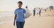 © peopleimages.com - Face, beach or happy black woman with plastic bag for earth day, sustainability or ocean cleaning project. Recycle, sustainability and portrait of volunteer at sea for NGO, accountability or charity