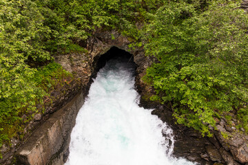 Wall Mural - Norway Tyntflossen waterfall on a cloudy summer day