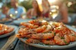 © itchaznong - A plate of shrimp is on a table with a group of people