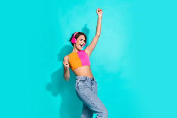 Poster - Photo of pretty lucky woman wear pink orange top singing enjoying music headphones empty space isolated teal color background