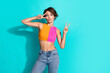 © deagreez - Photo of cheerful flirty woman wear pink orange top showing two v-signs empty space isolated teal color background