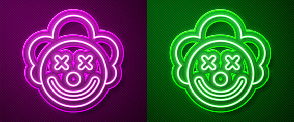 Wall Mural - Glowing neon line Clown head icon isolated on purple and green background. Vector