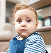 © peopleimages.com - Portrait, surprised and baby on floor in home for growth, development and care in family lounge. Eyes, child and young boy with emoji for learning, reflex and wow reaction on weekend in Ireland