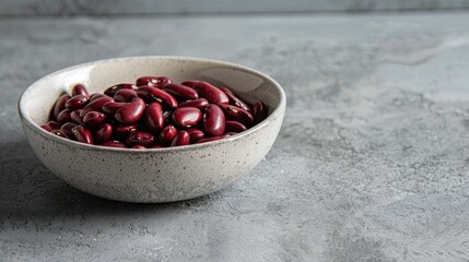 Wall Mural - Raw red beans displayed in a ceramic dish on a pale gray kitchen countertop Genuine Vegetarian Product