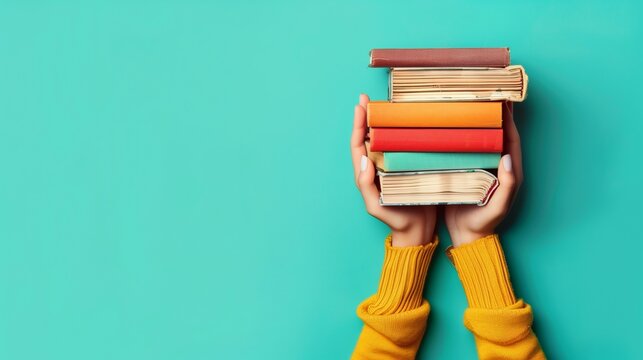 person hand holding stack of colorful books, study and education, intelligence and learning concept