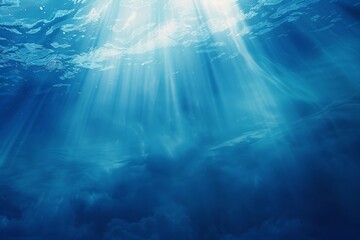 Tropical underwater deep ocean nature background with rays of sunlight in dark blue.