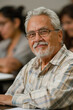 © AI_images - a Hispanic retired man attending a lecture at a community college