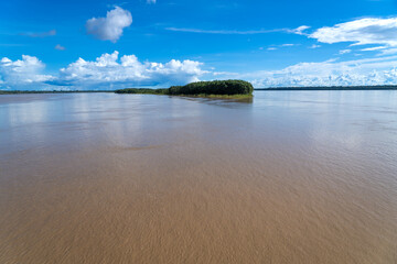 Wall Mural - Beautiful Amazon rainforest landscape sailing between forested islands by the moody river in summer. Concept of conservation, environment, ecology, nature, climate, biodiversity. Amazonas, Brazil