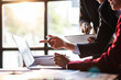 © Wasan - Business meeting, Company executives meeting discussing strategic analysis and business planning, group of people working with paperwork on a board room table at a business presentation or seminar.