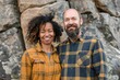© Markus Schröder - Portrait of a merry mixed race couple in their 40s dressed in a relaxed flannel shirt isolated on backdrop of ancient ruins