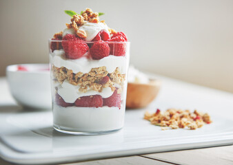 Sticker - Breakfast, cereal and yogurt with raspberry on plate for vegan food, health and protein in morning. Vitamins, glass and dairy in clear container with fruit for organic nutrition, weight loss and diet