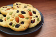 © jobi_pro - Delectable Homemade Almond with Mixed Nuts and Raisin Cookies on Wooden Table