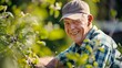© AounMuhammad - a mature age guy wearing a cap and casual shirt trimming plants in his garden and giving a smiling happiness gesture .