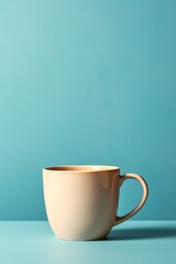 Cup of coffee on saucer isolated on blue background