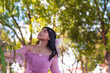 © Mdv Edwards - Curious young woman in pink dress exploring a green park