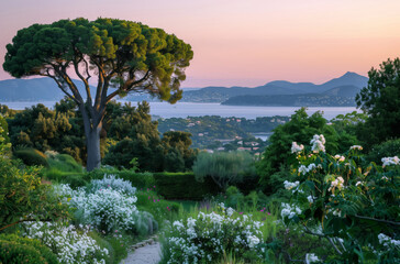 Wall Mural - Sunset landscape of a beautiful garden with flowers and trees overlooking a lake surrounded by mountains