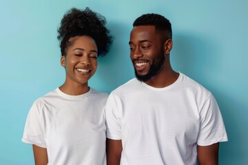 Wall Mural - Portrait of a satisfied afro-american couple in their 30s wearing a simple cotton shirt over pastel blue background