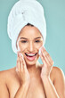 © CoetzeeRising/peopleimages.com - Portrait, towel and woman for skincare or cleansing, cotton pads and pamper for blue background. Cosmetology, smile or hygiene routine for spot control, retinol or hyaluronic acid for female person