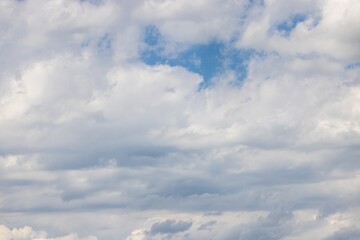 Wall Mural - Image of a partly cloudy sky with blue patches