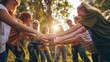 © Summit Art Creations - Diverse group of young volunteers holding hands in a circle in the woods. AIG535