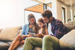 © Lyndon/peopleimages.com - Happy, tablet and family hug on sofa with child, education for development and elearning. Love, girl and browsing on touchscreen for digital app game, website for streaming movie and learning online