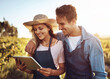 © Lyndon/peopleimages.com - Agriculture, smile and tablet with couple on farm together for growth, harvest or sustainability. Agro, love or research with man and woman outdoor in field for agribusiness, ecology or development