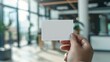 © Nuchylee - Close-up of a blank white business card mockup being handed over in an office setting