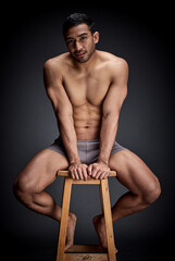 Poster - Confident, portrait and man body in studio fitness, wellness and muscular care for inspiration on chair. Person, aesthetic and exercise with strength workout for health on stool by black background