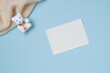 © Solesto - Empty white paper list with bear toy on blue background from above. Copy space