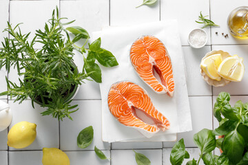 Wall Mural - Fresh salmon steaks with herbs and ingredients for cooking, top view