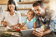 © Lyndon/peopleimages.com - Parents, child and cooking with tablet, online for recipe or ingredients on kitchen counter for dinner. Family, healthy and food for meal prep, nutrition and together with bonding for eating in home