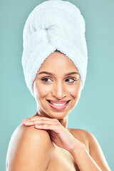 Wall Mural - Woman, idea and towel on head in studio for shower, hygiene and smile for cleaning. Model girl, happy and thinking for wellness, grooming and glow in morning with skincare by blue background