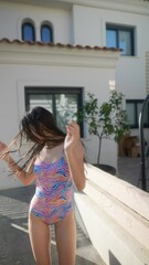 Wall Mural - A young woman is happily enjoying a sunny day outdoors, wearing a colorful swimsuit