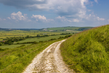 a chalk pathway in the sussex countryside with a view over a vast landscape
