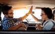 © peopleimages.com - Happy couple, high five and vehicle for travel, road trip and destination achievement with smile. Car, transport and married people with hand gesture for journey goal, adventure or vacation location