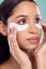 Poster - Woman, hands and eye patch for beauty and skincare, hydration and refresh on blue background. Closeup, dermatology and facial treatment for collagen, thinking and detox for female person in studio