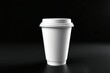 © Rayan Heaven - Mockup of take away paper coffee cup white with space for test black background. Product shot of a blank coffee cup, disposable coffee cup on a desk, beverage branding. Marketing mockup