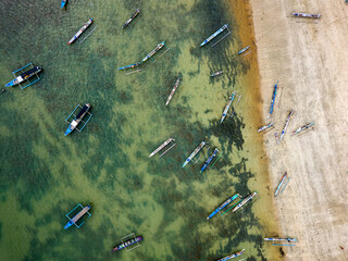 Wall Mural - Top down aerial view of wooden outrigger boats in Kuta, Lombok