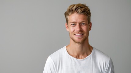 In this closeup picture, we can see a handsome blonde Scandinavian man with clean teeth smiling for a dental ad. He has fresh trendy hair and has a strong jawline.