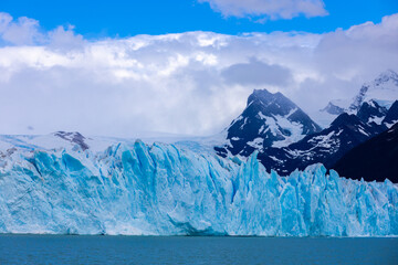 Blu ice glacier Perito Moreno in Patagonia, Argentina. Huge ice seracs wall above the lake on a cloudy nasty day. South America Arcitc landscape on polar latitude. Mountain glacier scenic landscape