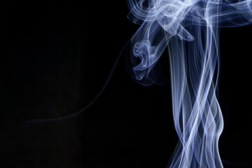 Wall Mural - close up of incense smoke abstract on black background