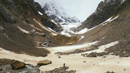 Wall Mural - couple against background Chalaadi Glacier Caucasus mountains, aerial view