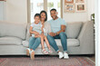 © peopleimages.com - Family, portrait and happy for love, relax and trust in home living room with mother, father and child. Parents, kid and smile as household for care, bond or support together in house lounge on sofa