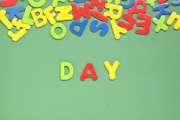 Poster - Word Day made of magnetic letters on green background, flat lay. Learning alphabet