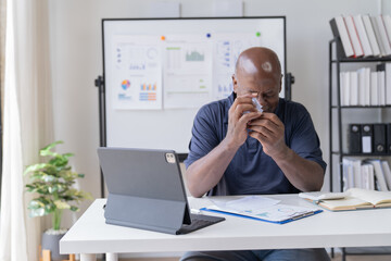 Creative african businessman senior american worker using computer device in office,chat online, thinking business solution planning difficult decision pondering strategy come up with idea.