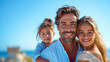 © aekkorn - Happy parents with their children, blue sky on background. copy space.
