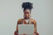 © gankevstock - Trendy university student using a laptop for research and studies