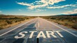 © nopommajun - The word START is painted on a road, signaling the beginning of a journey with scenic landscape in the background