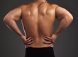 © Flashizzle/peopleimages.com - Back pain, stress and fitness man in studio with workout mistake, fail or muscle inflammation on black background. Sports, injury and bodybuilder with backache, spine or anatomy, risk and emergency