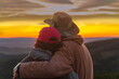 © tramp51 - two silhouettes of two tourists in love against the background of an evening sunset in the mountains